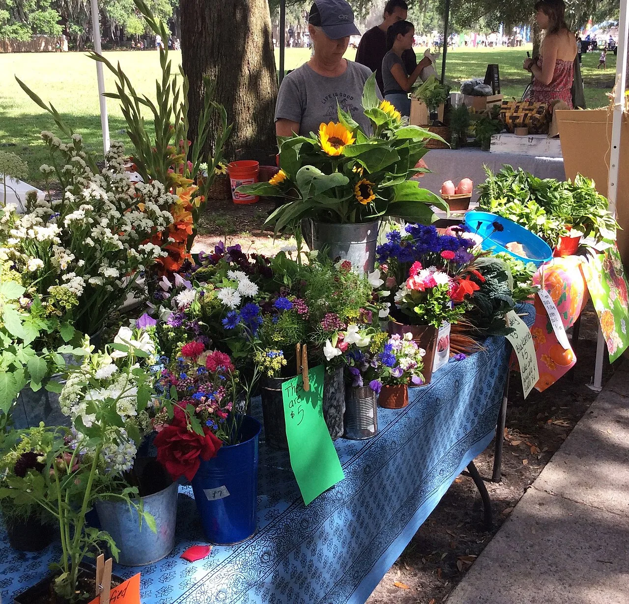 Cut flowers displayed in buckets at a farmers market