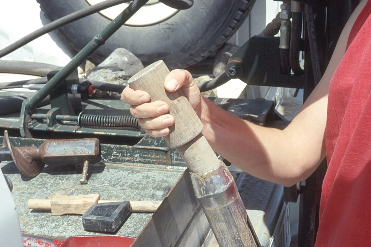A USDA NRCS worker handling soil-sampling equipment